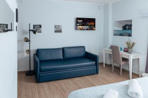a living room with a blue couch and a desk at Cufà in Pescara