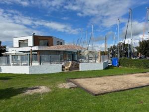 a house with masts on top of it at Minicamping Marina Warns in Molkwerum