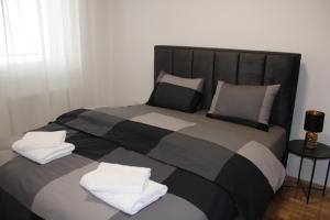 a bed with two pillows on top of it at Apartment M in Smederevo