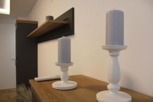 two candles sitting on top of a wooden table at Apartment M in Smederevo