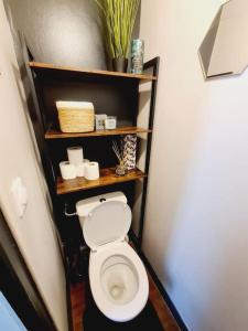 a bathroom with a white toilet in a room at L'anjou - St Nazaire - Comme à la maison in Saint-Nazaire