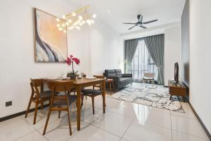 a dining room and living room with a table and chairs at Opus Residences by Opus Hospitality in Kuala Lumpur