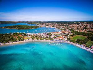an aerial view of a beach with boats in the water at Ai Pini Medulin Resort in Medulin +15 photos