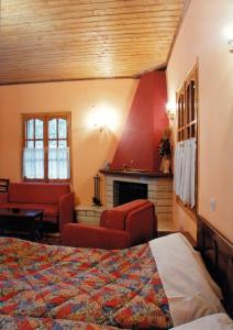 a hotel room with a bed and a fireplace at Epavli Antonis in Konitsa