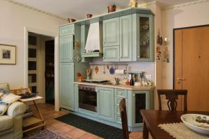 a kitchen with blue cabinets and a table at Condominio Maria Ida in Caorle