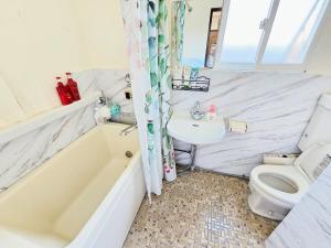 a bathroom with a tub and a toilet and a sink at Downtown Tokyo/Taito-gu/2min walk nearest sta/Ueno/Wi-Fi/302 in Tokyo +35 photos