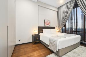 a bedroom with a bed and a large window at Opus Residences by Opus Hospitality in Kuala Lumpur