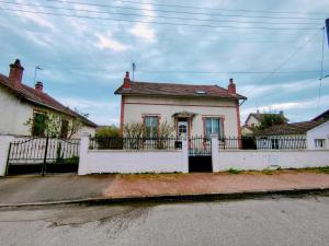 una casa blanca con una valla blanca delante de ella en Home - Champoulains - Séjour à Auxerre, en Auxerre