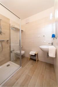 a bathroom with a shower and a sink and a toilet at 8 Grappoli Agritur in Trento