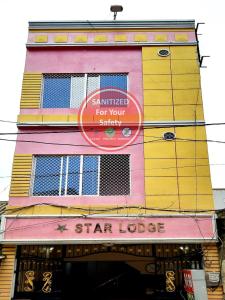 a tall building with a star lease sign on it at Hotel Star Lodge Puri in Puri