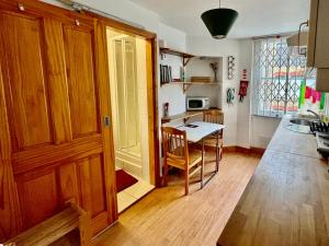 a kitchen with a wooden door and a table at Stay in Bloomsbury1 in London