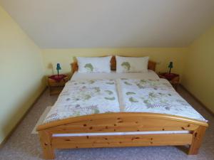 a bedroom with a wooden bed with two night stands at Ferienwohnung Schneider in Sasbach am Kaiserstuhl