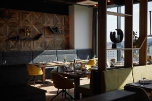 un restaurant avec des tables et des chaises et une fenêtre dans l'établissement Impulshotel FREIGOLD, à Freistadt