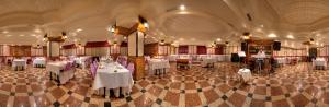 a dining room with white tables and chairs at Dündar Hotel in Konya