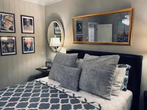 a bedroom with a bed with pillows and a mirror at Apartments At The Sentrum in Kristiansund