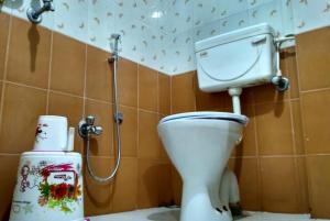 a bathroom with a toilet and a shower at Hotel Star inn Sea View Hotel GRG in Puri