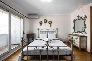 - une chambre avec un lit en métal et un miroir dans l'établissement Estrella, Nilie Hospitality MGMT, à Thessalonique