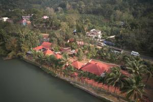 an aerial view of a house next to a river at Kandamath Heritage Resort in Kolattupuzha
