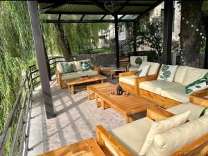 a patio with couches and tables on a patio at Bhurban Valley Cottages 2 in Bhurban
