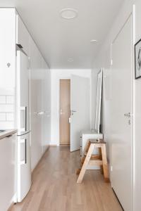 a hallway with white walls and a wooden table at Studio apartment near Kerava train station in Kerava