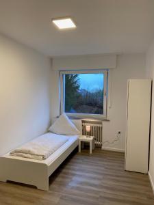 - une petite chambre avec un lit et une fenêtre dans l'établissement CaJu-Stays Monteurwohnung - Barntrup, Blumenstr. 1b, à Barntrup