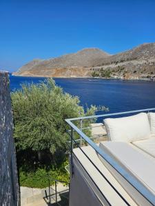 a balcony with a view of a body of water at The Anchor House in Symi