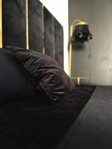 a black pillow sitting on top of a bed at Luksusowy Apartament Joker 2 in Szklarska Poręba