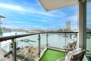 a balcony with a view of the water at BEST THAMES VIEW in TOWN! LARGE LUXXE NOMAD DESIGN FAMILY HOME in London