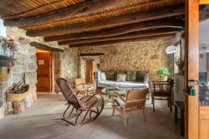 a living room with rocking chairs and a couch at Mas Coquells Habitación doble de 2 camas in Vilanant