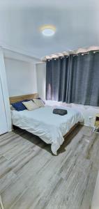 a bedroom with a large bed in front of a window at Twin Palms @ The Basin in St Georges Basin