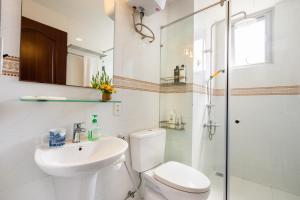 a bathroom with a toilet and a sink and a shower at Convinia Apartment in Ho Chi Minh City