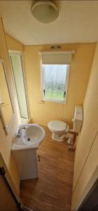 uma pequena casa de banho com lavatório e WC em Elle em Mablethorpe