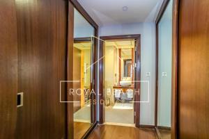 a glass door leading into a room with a bathroom at Royal Beach Residence in Dubai