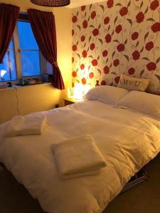 uma cama branca num quarto com uma janela em Lovely riverside flat em Stifford