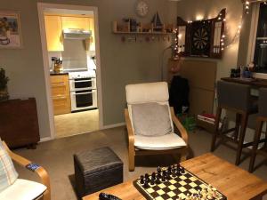 a living room with a chess board on a table at Lovely riverside flat in Stifford