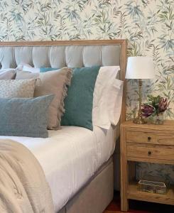 a bed with pillows and a lamp on a night stand at LAR DA REVOLTA in Cedeira