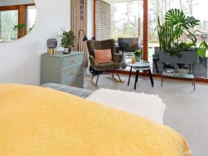 a bedroom with a bed and a desk and a chair at 5 person holiday home in Thyholm-By Traum in Thyholm