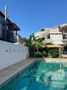 a swimming pool in front of a house at İberia Villas in Sarigerme