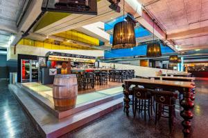 a restaurant with a bar with tables and chairs at MyTirol in Biberwier