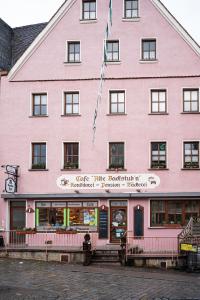 un edificio rosa con un cartel delante en Cafe Alte Backstubn, en Spalt