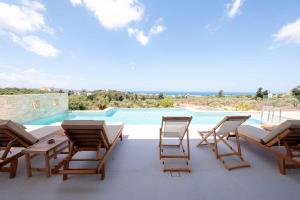 a patio with chairs and a swimming pool at Star Luxury Villa - Private pool, gym, playground in Kato Daratso