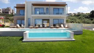 a house with a swimming pool in front of a house at Star Luxury Villa - Private pool, gym, playground in Kato Daratso