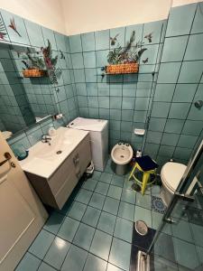 ポルト・エルコレにあるCASETTA A PORTO ERCOLEの青いタイル張りのバスルーム(洗面台、トイレ付)