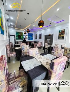 a restaurant with tables and chairs in a room at LA GRANITA HOTEL AND SUITES in Ado Ekiti