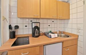 a kitchen counter with a sink and a coffee maker at Fh Blau in Warenthin