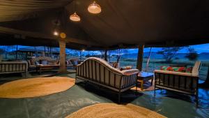 aented room with chairs and tables in a safari tent at Kananga Special Tented Camp in Banagi