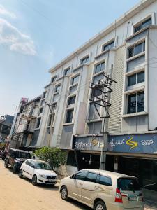 two cars parked in front of a building at Western Silicon Hotel in Bengaluru
