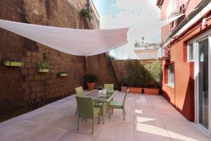 a patio with a table and chairs and a white curtain at B&B La Cassa Armonica in Pozzuoli