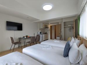 Postel nebo postele na pokoji v ubytování ESLEAD HOTEL Namba South Ⅰ
