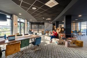 a room with people sitting on a couch in a office at COWOOL TOULOUSE in Toulouse